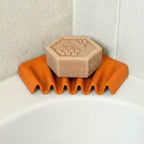 Ripple self-draining corner soap dish for shower and bathroom by Zura Nest in orange